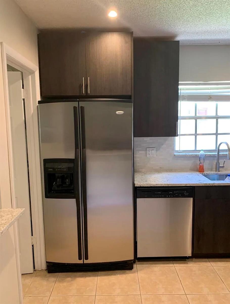A kitchen features stainless steel appliances, dark wood cabinets, and light granite countertops — 22324 SW 57th Circle, Boca Raton FL 33428, BOCA RATON, FL
