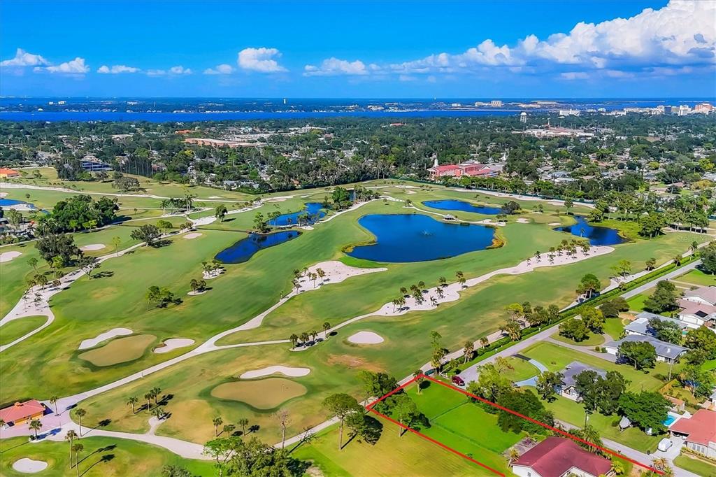 An aerial view shows a vacant residential lot outlined in red bordering a golf course — 4704 18TH AVENUE W, BRADENTON, FL