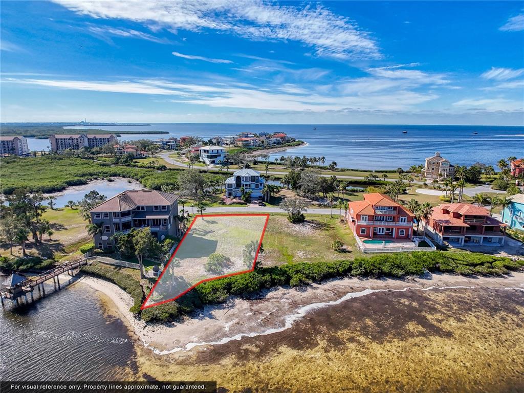 An aerial view shows a vacant waterfront lot outlined in red between two large houses — Lot 46 HARBORPOINTE DR., PORT RICHEY, FL