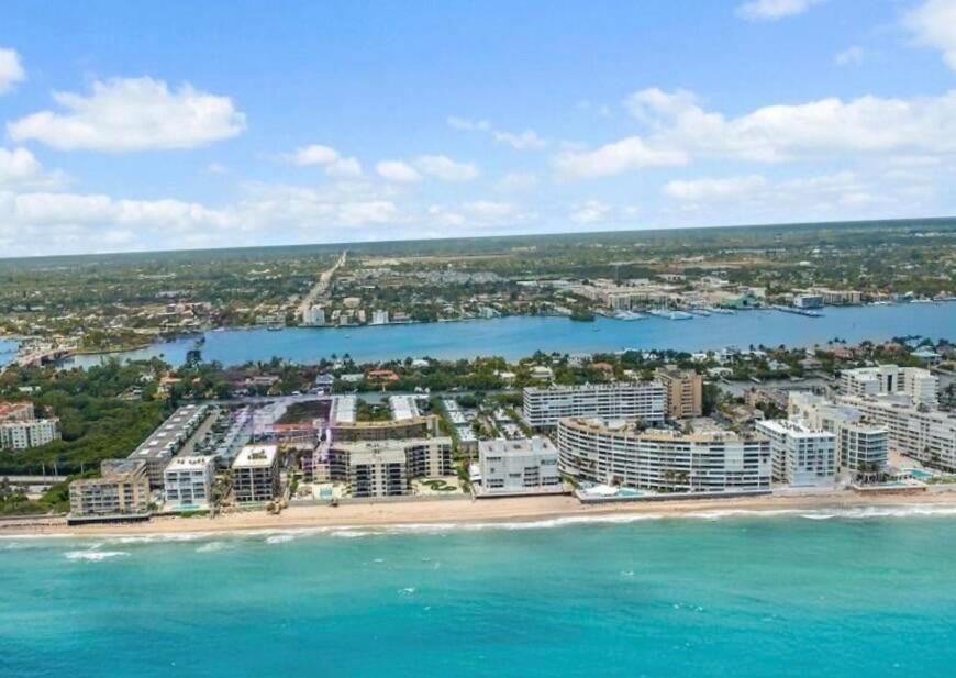 Aerial view of beachfront condominiums along the coast with a waterway in the background — 4501 S Ocean Boulevard # D4, South Palm Beach FL 33480, SOUTH PALM BEACH, FL