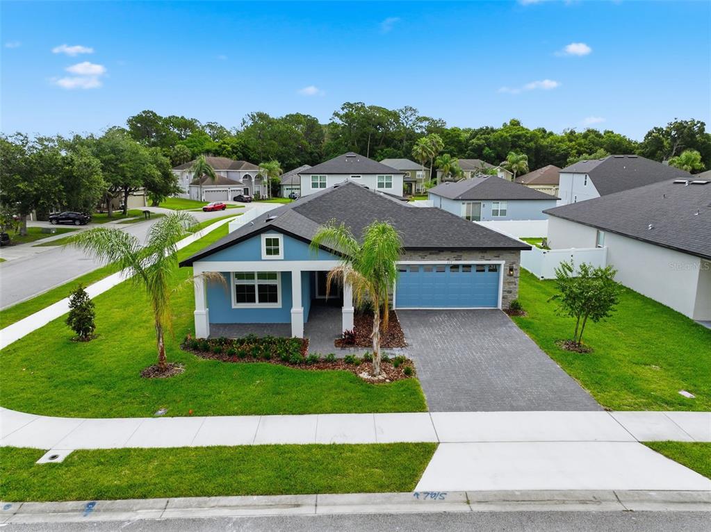 A blue single-story house with a two-car garage and a paved driveway — 117 HADLEY DRIVE, SANFORD, FL
