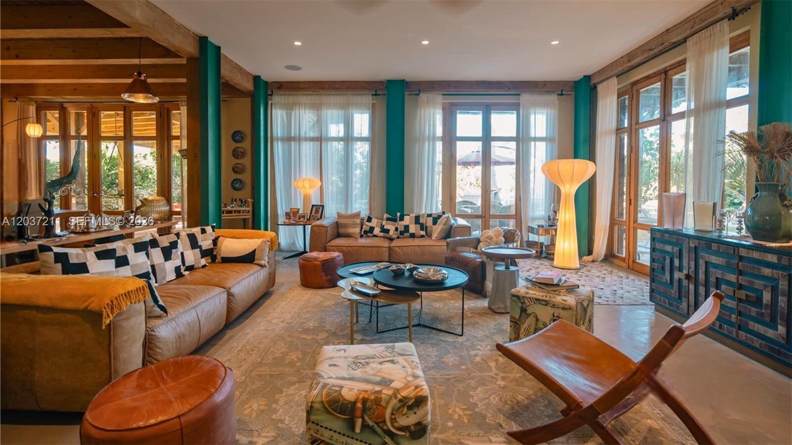A living room features leather sofas, wooden beams, teal pillars, and large floor-to-ceiling windows — 0 Las iguanas, FL