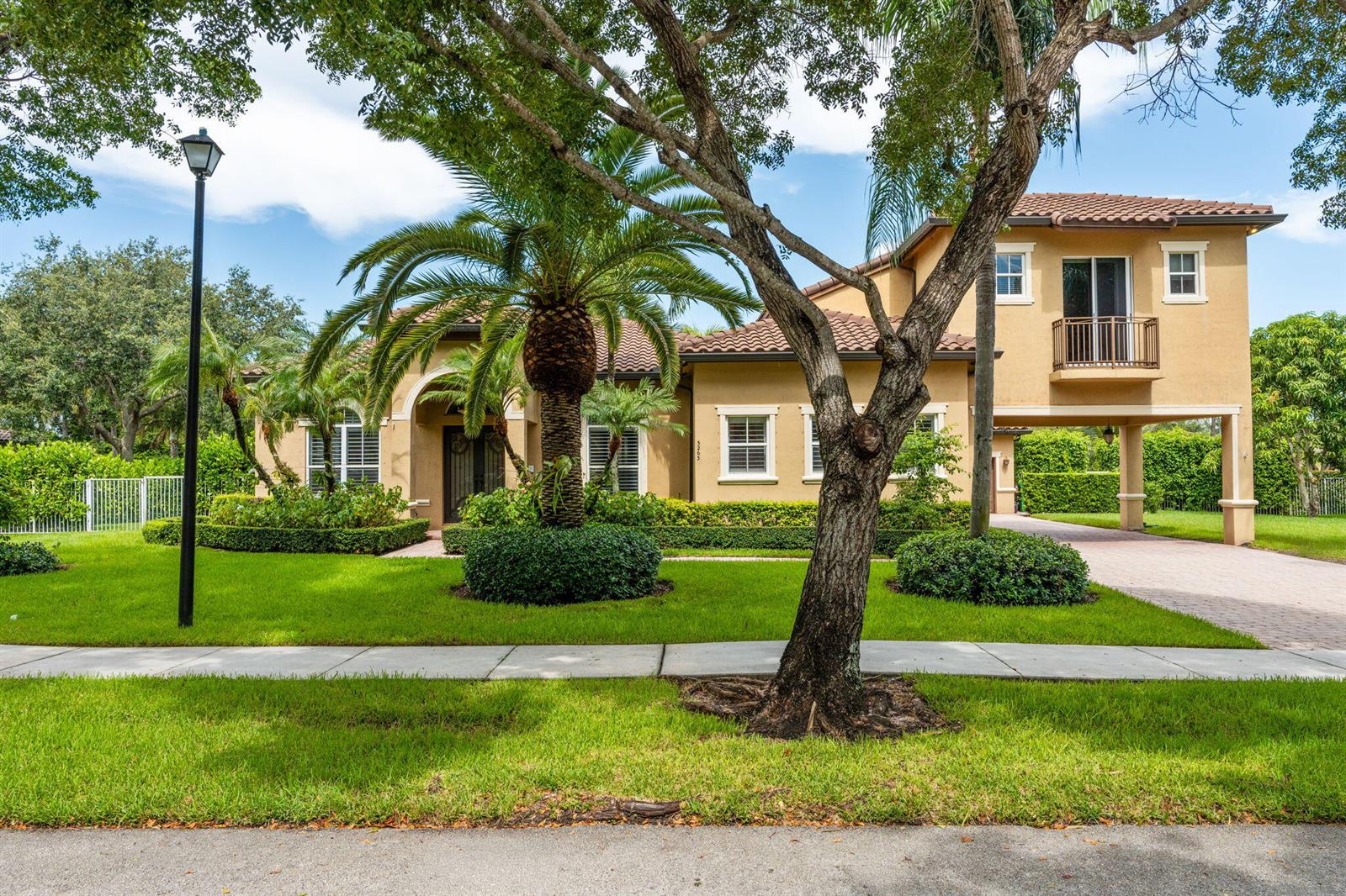 A two-story stucco house with a tile roof, palm trees, and a paved driveway — 3263 SW 138th Way, Davie FL 33330, DAVIE, FL