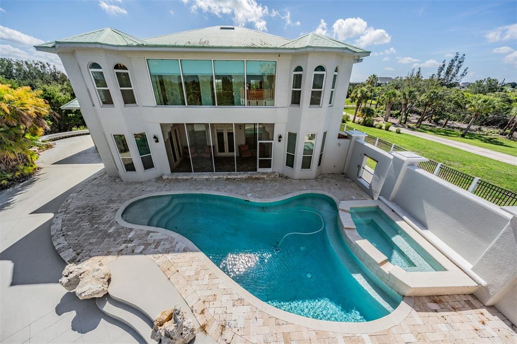 An aerial view of a two-story house with a swimming pool and attached spa — 4710 TROYDALE ROAD, TAMPA, FL
