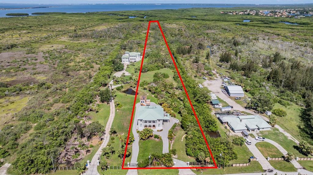 An aerial view shows a large property with two houses outlined in red — 4710 TROYDALE ROAD, TAMPA, FL