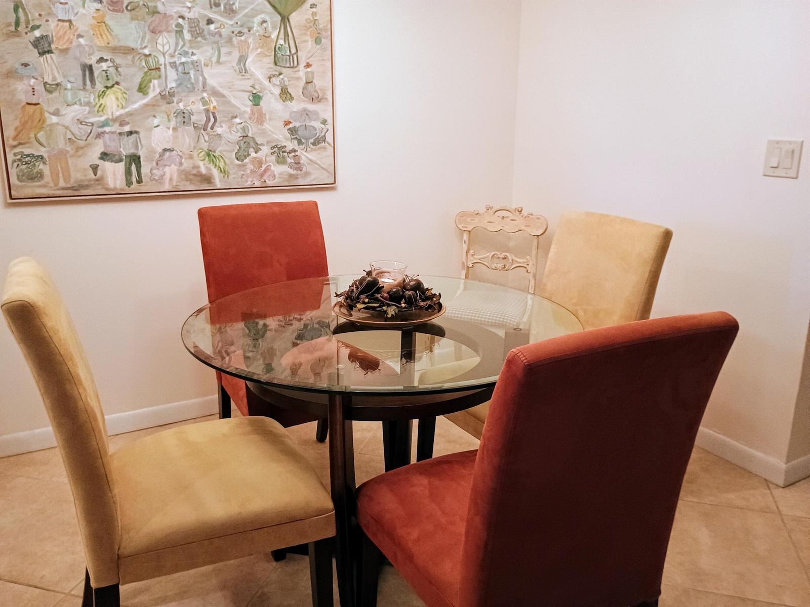 A dining area features a glass-topped table with four chairs and a large wall painting — 14716 Canalview Drive # D, Delray Beach FL 33484, DELRAY BEACH, FL