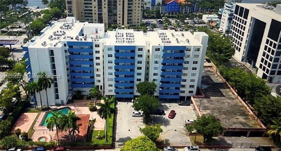 A small kitchen features white cabinets, stainless steel appliances, and light-colored countertops — 5050 NW 7th St # 511, Miami FL 33126, MIAMI, FL