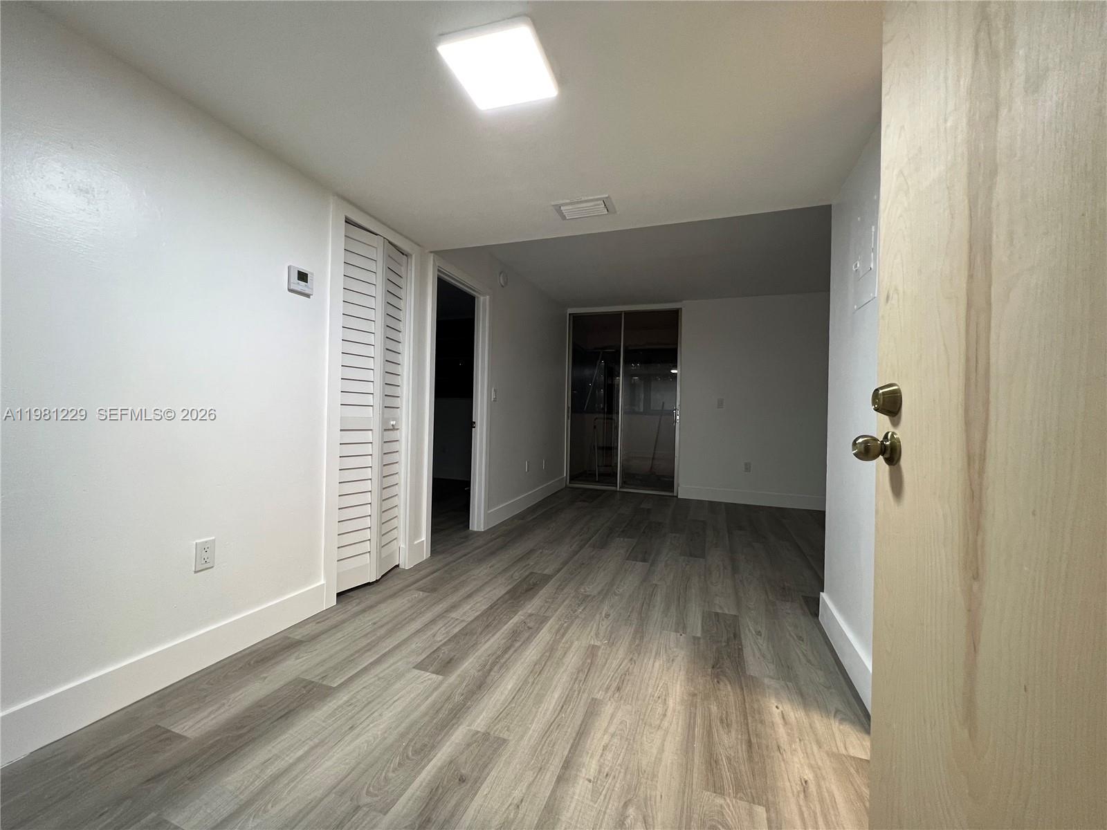 A modern kitchen features white cabinets, stainless steel appliances, and light-colored speckled countertops — 5050 NW 7th St # 511, Miami FL 33126, MIAMI, FL