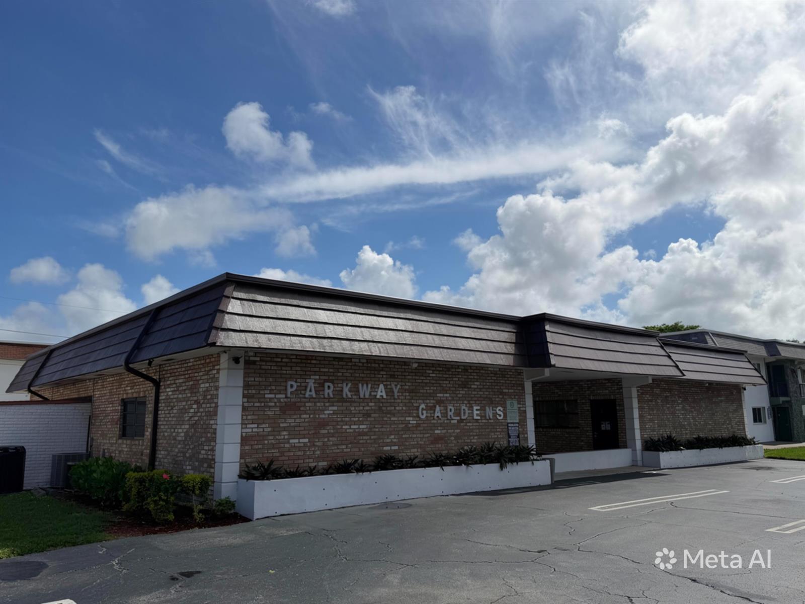 A brick exterior building with a dark mansard roof and the sign Parkway Gardens — 320 SW 1st Street # 2, Pompano Beach FL 33060, POMPANO BEACH, FL