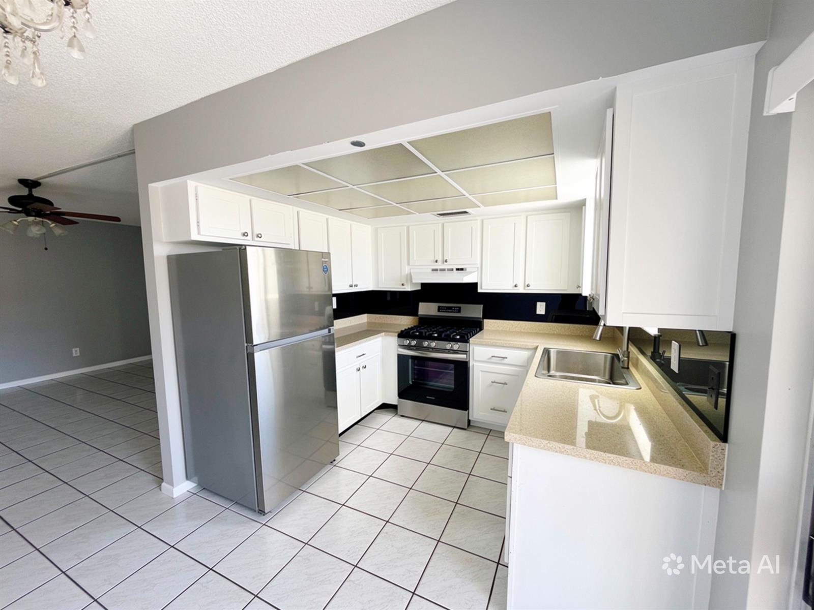 A kitchen features white cabinets, stainless steel appliances, beige countertops, and a tiled floor — 320 SW 1st Street # 2, Pompano Beach FL 33060, POMPANO BEACH, FL