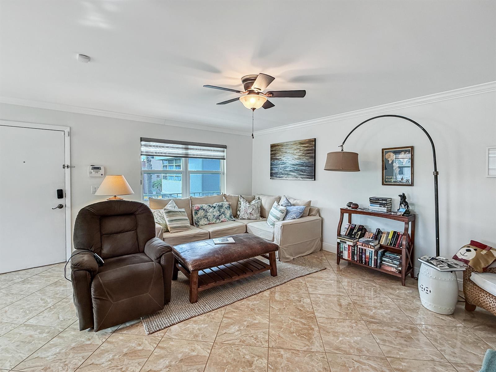 A living room features a beige sectional, a brown leather recliner, and tiled flooring — 334 Piedmont G, Delray Beach FL 33484, DELRAY BEACH, FL