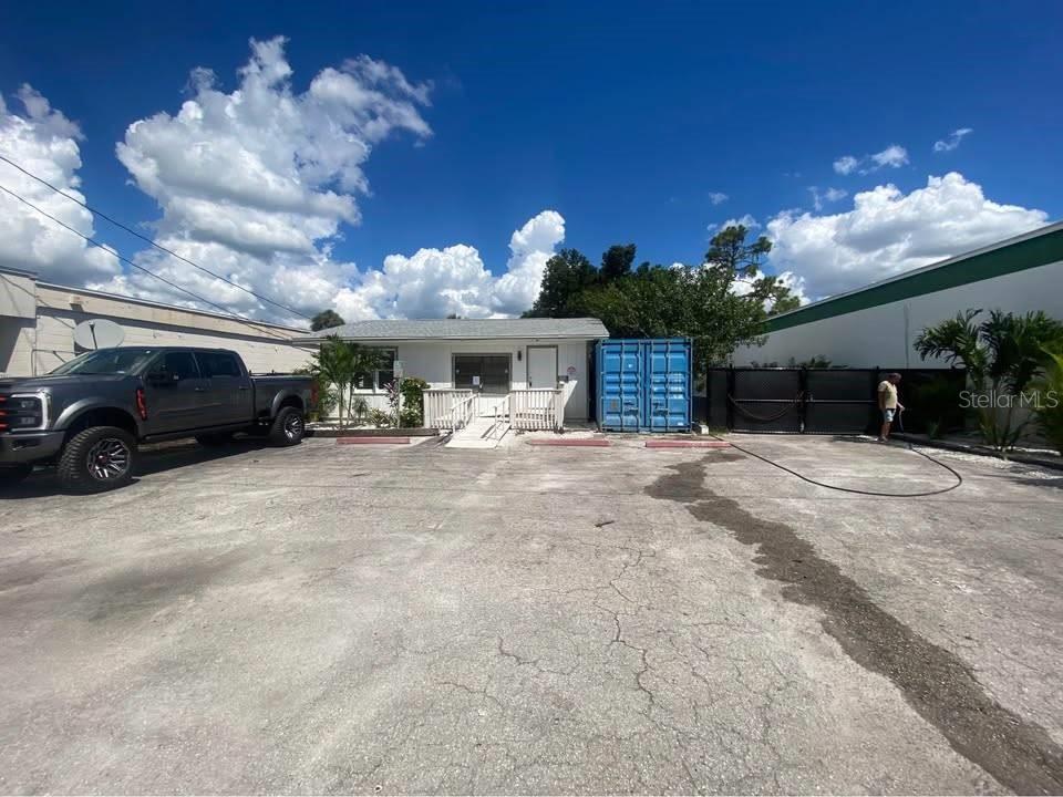 A single-story building with a ramp, a blue shipping container, and a truck parked outside — 1254 PINEY ROAD, NORTH FORT MYERS, FL