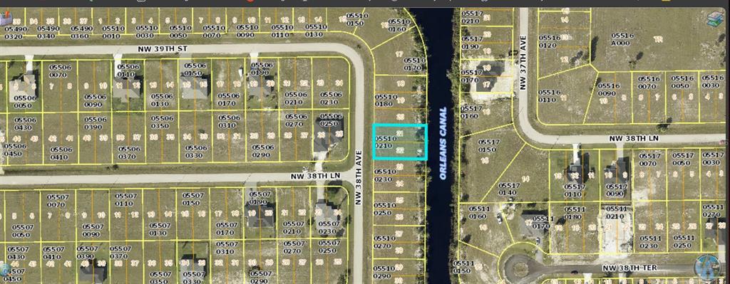 This is a map showing a vacant residential lot highlighted in blue along a canal — 3833 NW 38TH AVENUE, CAPE CORAL, FL