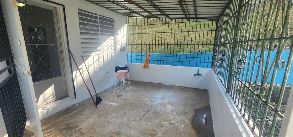 A covered outdoor patio with concrete flooring, white walls, and green metal security bars — KM 12.2 INT LAS PAPAYAS RD (SR-185) Lots A and B, CAROLINA, PR