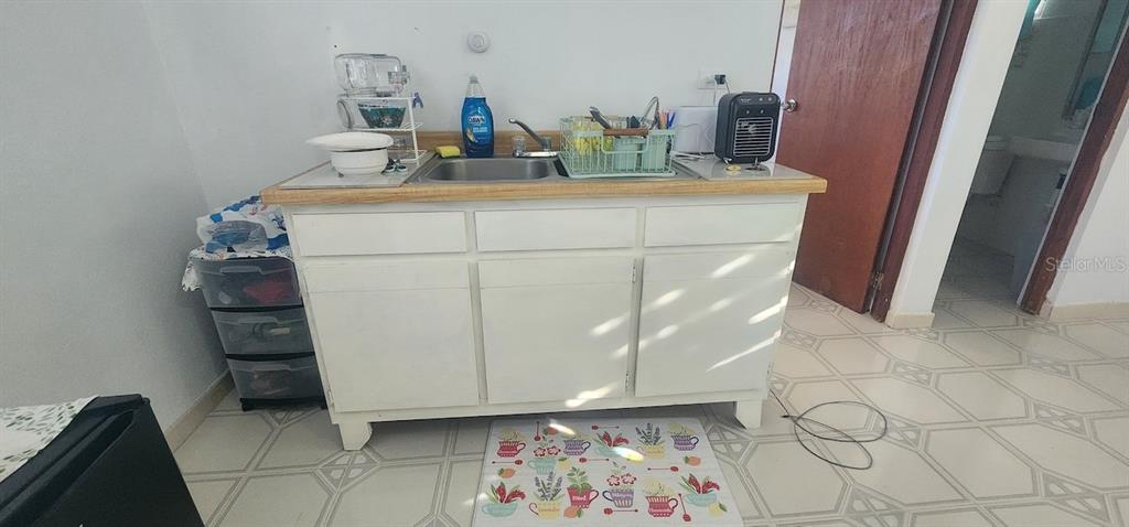A white kitchen cabinet with a sink and countertop sits on a tiled floor — KM 12.2 INT LAS PAPAYAS RD (SR-185) Lots A and B, CAROLINA, PR
