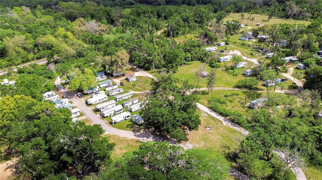 An aerial view shows a rural property with multiple mobile homes and scattered trees — 19140 US HIGHWAY 301, DADE CITY, FL