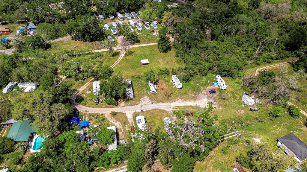 An aerial view shows a rural property with multiple mobile homes, trees, and dirt roads — 19140 US HIGHWAY 301, DADE CITY, FL