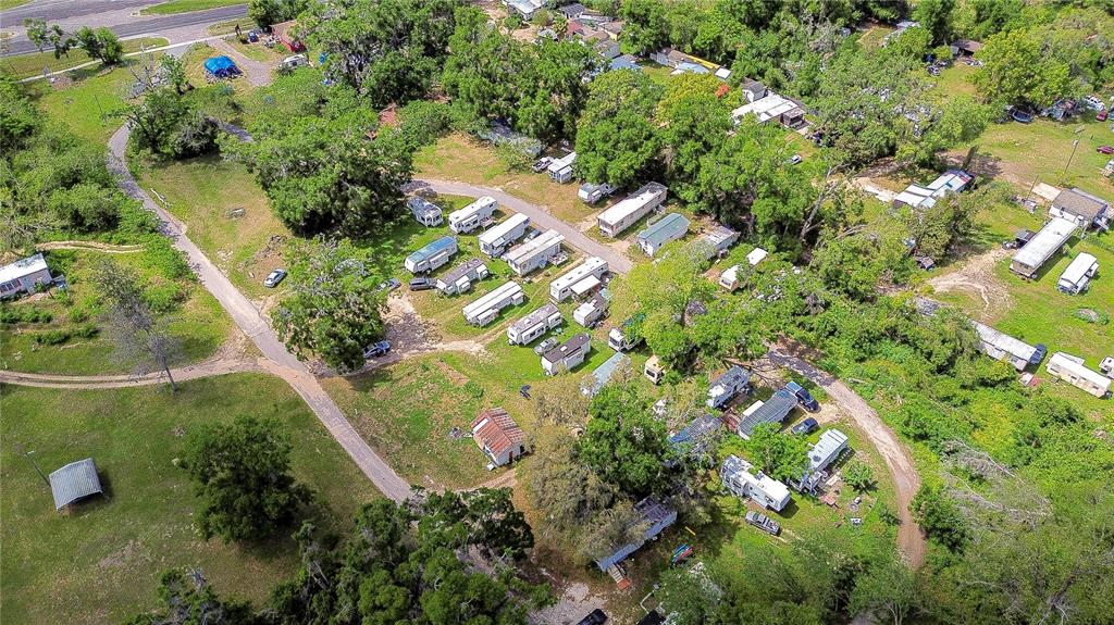 An aerial view shows a rural property featuring multiple mobile homes scattered among trees — 19140 US HIGHWAY 301, DADE CITY, FL