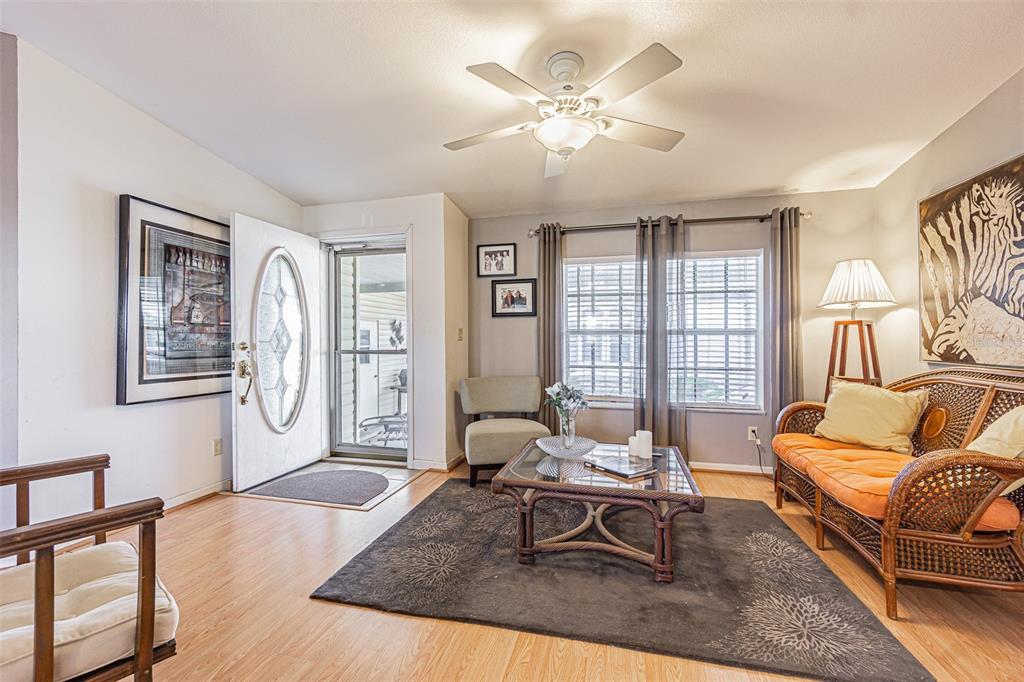 A living room features light wood flooring, a ceiling fan, and a wicker sofa — 37627 LORENA AVENUE, ZEPHYRHILLS, FL