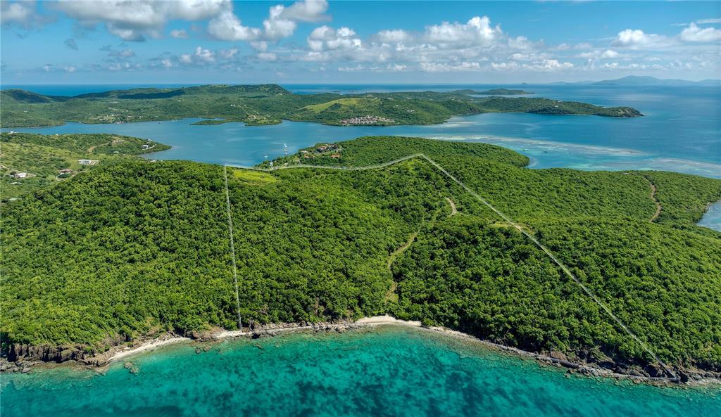 An aerial view shows a lush, hilly coastal property outlined by white boundary lines — PR 998 Km 3.0 PLAYA SARDINAS, CULEBRA, PR