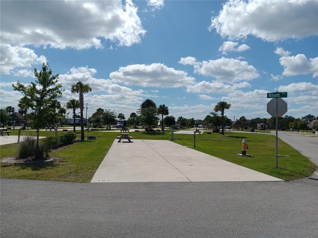 An outdoor RV campsite features a concrete pad, a picnic table, and a fire hydrant — 16950 COUNTY ROAD 630 E UNIT 107, LAKE WALES, FL
