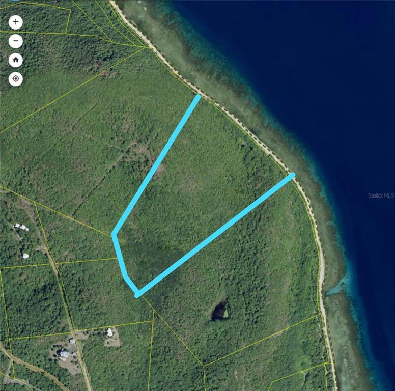 An aerial map shows a plot of land outlined in blue along a coastal shoreline — 250 Zoni PLAYA LARGA, CULEBRA, PR