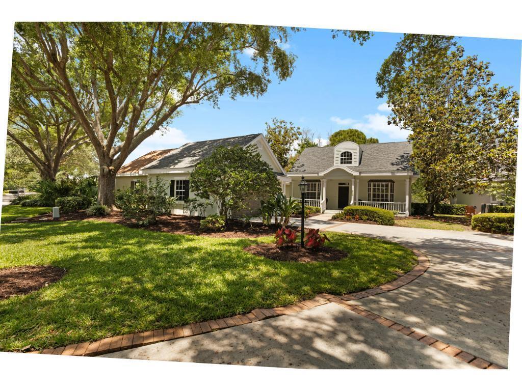 A single-story house with a gray roof, white siding, and a curved concrete driveway — 814 Carolina Circle SW, Vero Beach FL 32962, VERO BEACH, FL