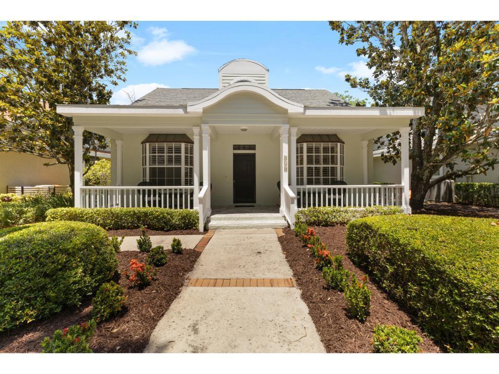 A light green house with a front porch, bay windows, and a central roof dormer — 814 Carolina Circle SW, Vero Beach FL 32962, VERO BEACH, FL