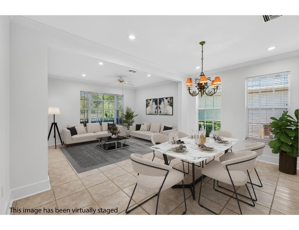 This virtually staged image shows an open-concept dining and living area with tile flooring — 814 Carolina Circle SW, Vero Beach FL 32962, VERO BEACH, FL