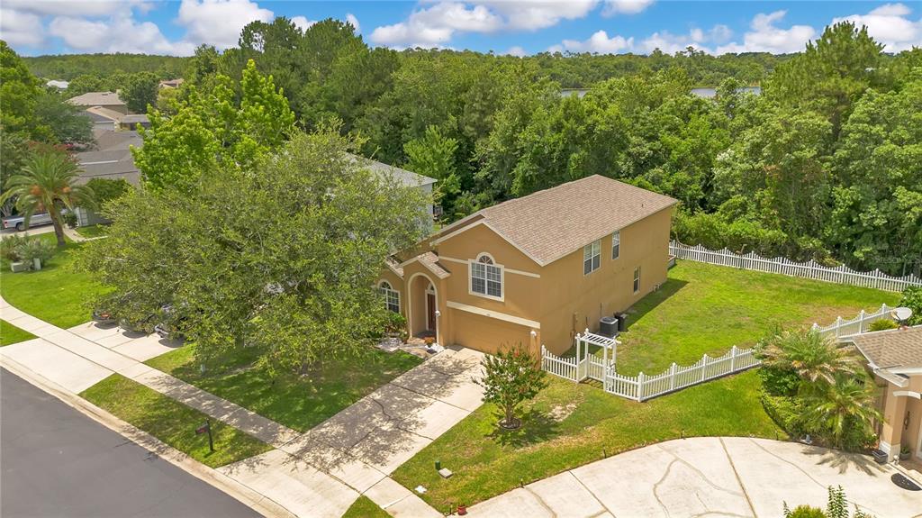 An aerial view of a tan two-story house with a driveway and a white fence — 469 CAREY WAY, ORLANDO, FL