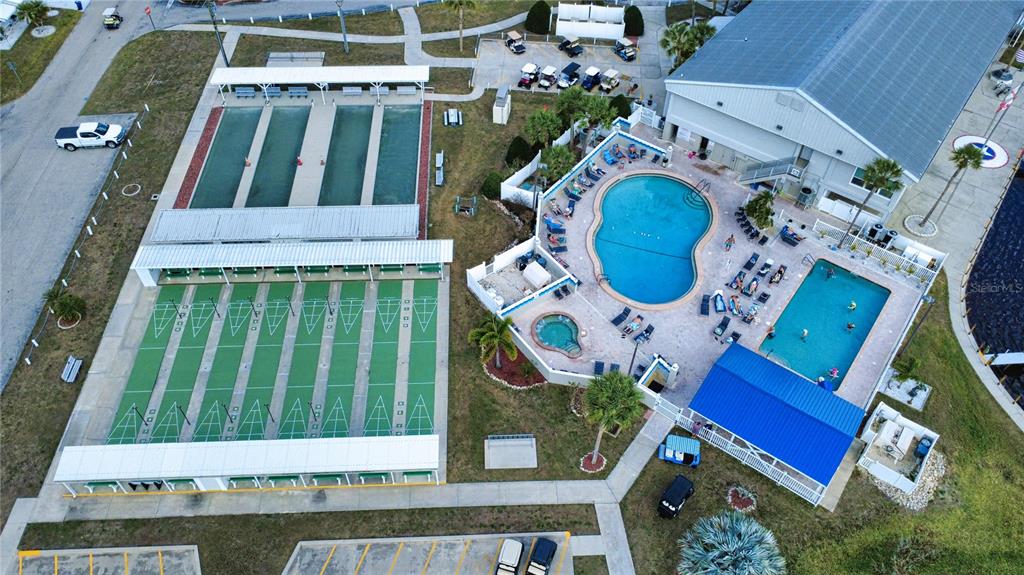 An aerial view shows a community recreation area with shuffleboard courts, two pools, and parking — 530 PARKWOOD AVENUE, NORTH PORT, FL