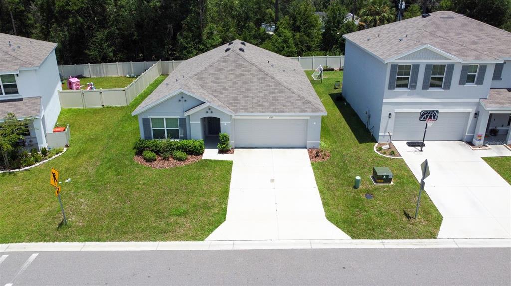 An aerial view shows a single-story house with a gray roof and a concrete driveway — 6747 SE 3RD LOOP, OCALA, FL