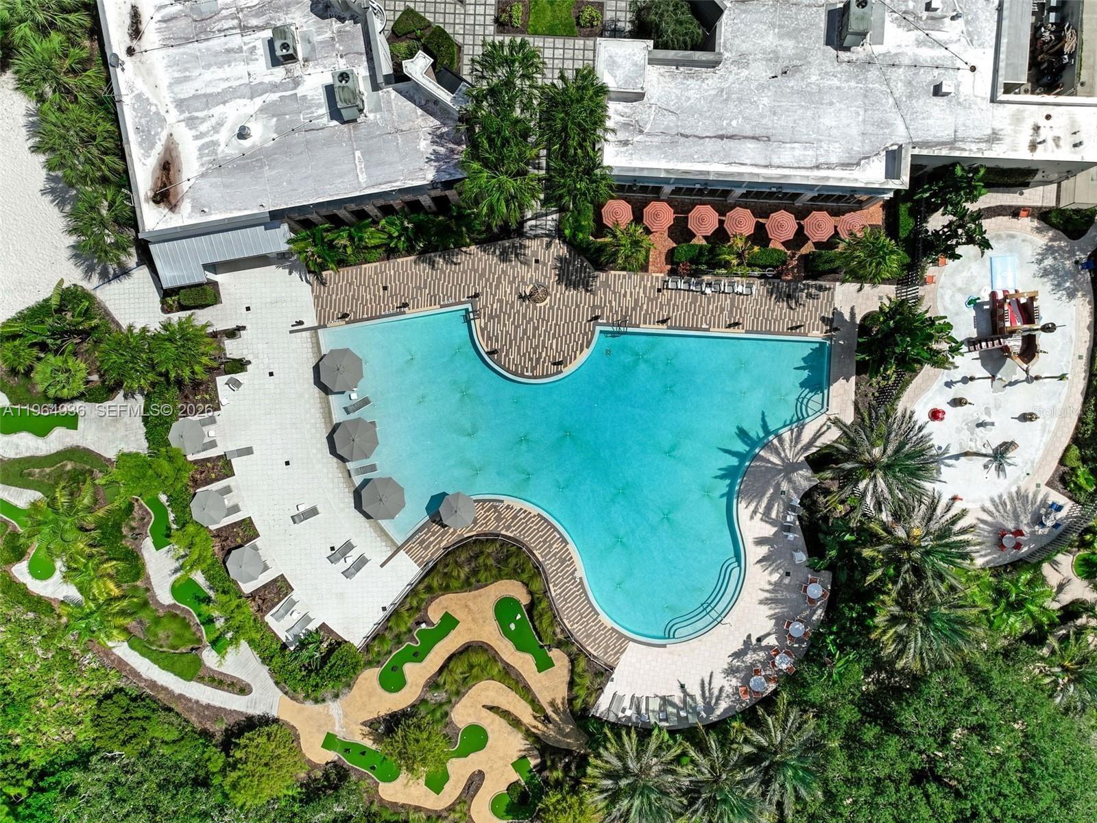 An aerial view shows a swimming pool, a miniature golf course, and a building exterior — 742 Langboat Dr, Davenport FL 33896, DAVENPORT, FL