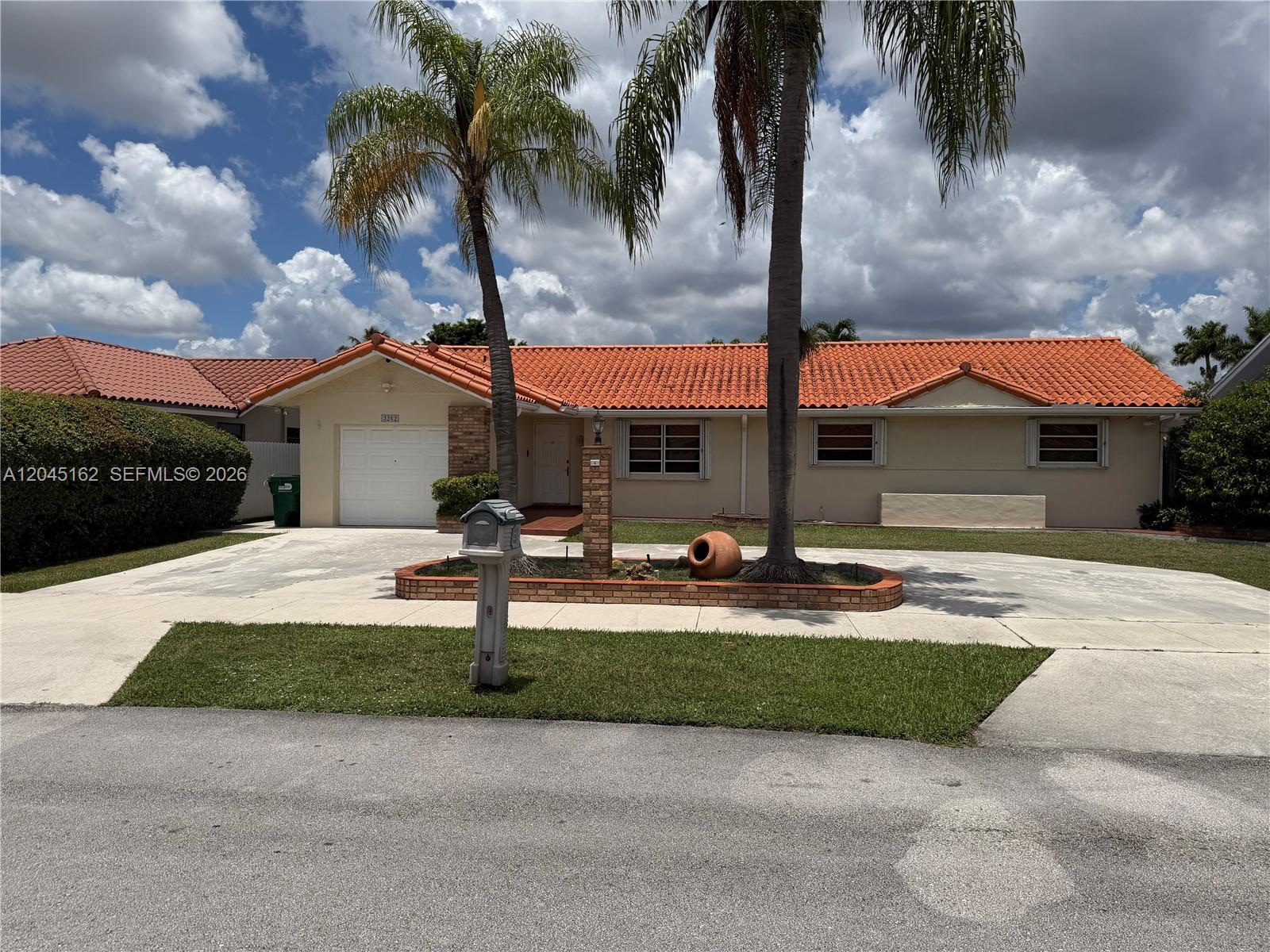A single-story house with a terracotta tile roof, a brick planter, and two palm trees — 3262 SW 139th Pl, Miami FL 33175, MIAMI, FL