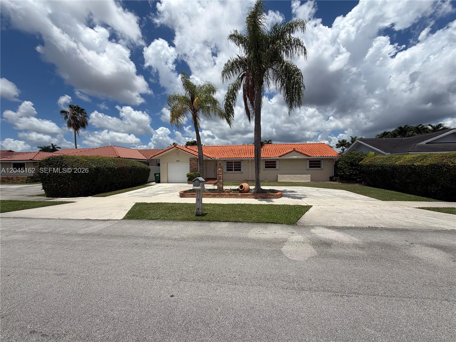 A single-story house with a red tile roof and two palm trees in the front yard — 3262 SW 139th Pl, Miami FL 33175, MIAMI, FL
