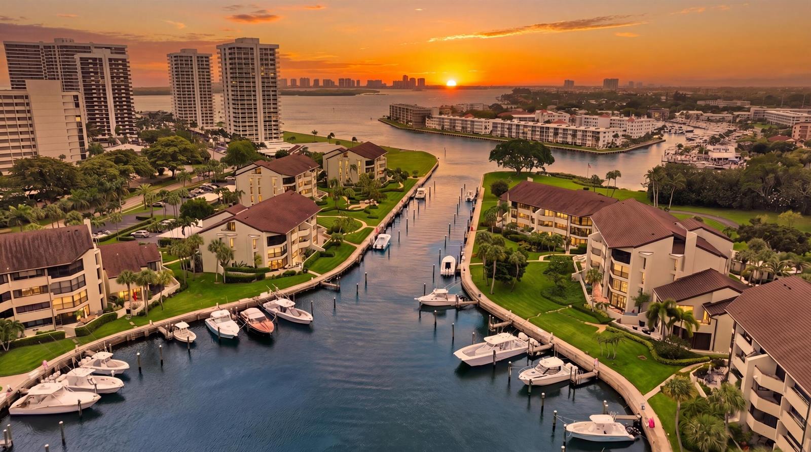 An aerial view of a waterfront residential complex with docked boats at sunset — 1109 E Marine Way E, North Palm Beach FL 33408, NORTH PALM BEACH, FL