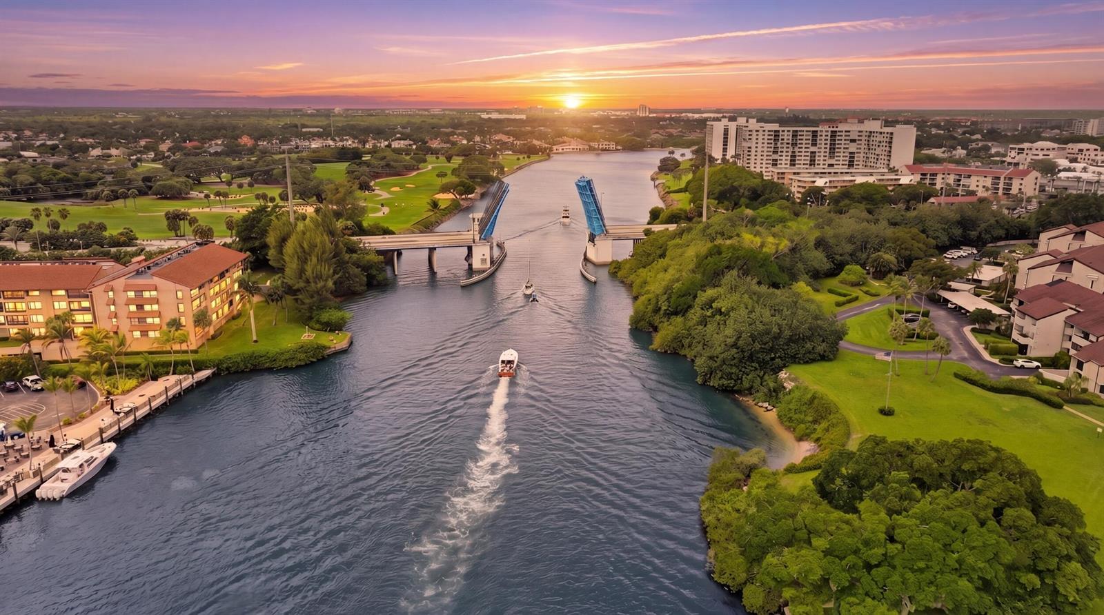 An aerial view of a drawbridge over a canal at sunset with boats passing through — 1109 E Marine Way E, North Palm Beach FL 33408, NORTH PALM BEACH, FL