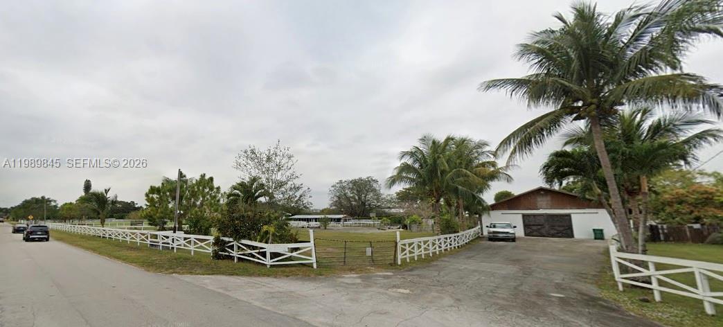 A white-fenced property features a paved driveway, a barn-style building, and several palm trees — 6375 SW 125th Ave, Miami FL 33183, MIAMI, FL