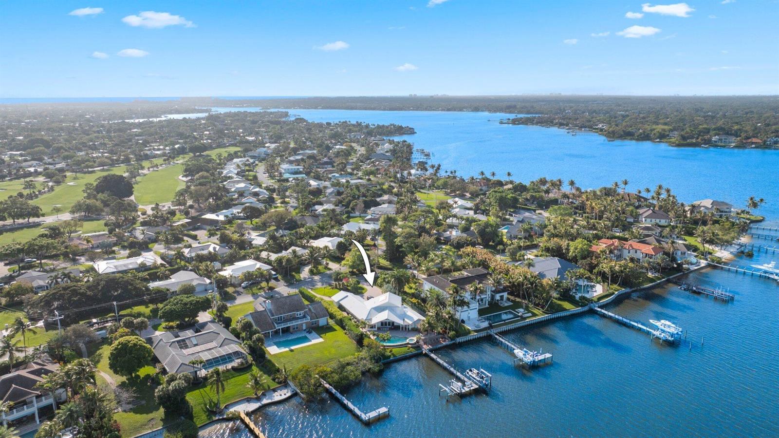 An aerial view shows a waterfront house with a pool and private dock — 163 River Drive, Tequesta FL 33469, TEQUESTA, FL