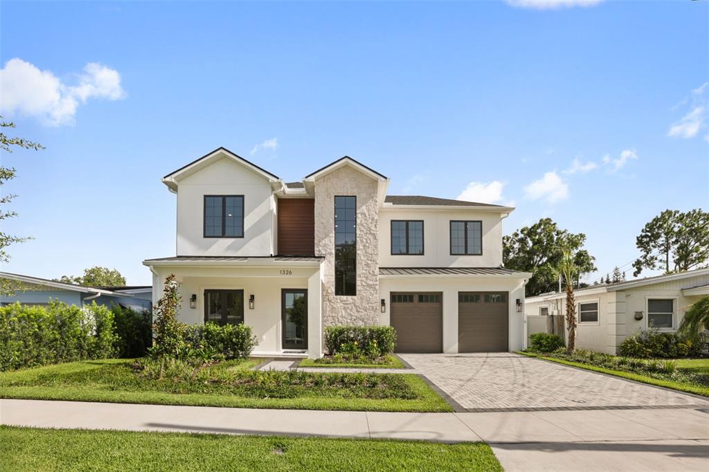 A two-story house with white stucco, stone accents, and a two-car garage — 1326 W NEW HAMPSHIRE STREET, ORLANDO, FL