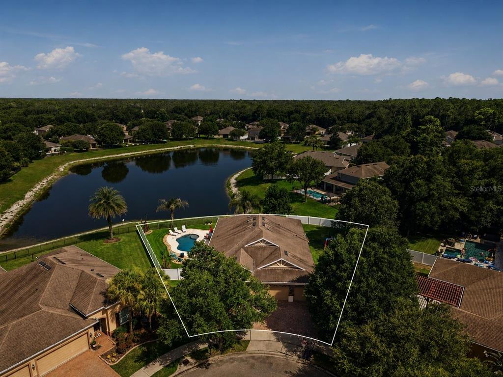 A single-story house with a stone facade, a three-car garage, and a paved driveway — 471 BREEDERS CUP COURT, DELAND, FL