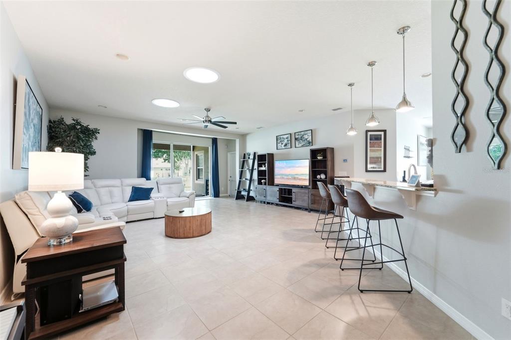 A single-story house with a stone facade, a multi-car garage, and a landscaped front yard — 471 BREEDERS CUP COURT, DELAND, FL