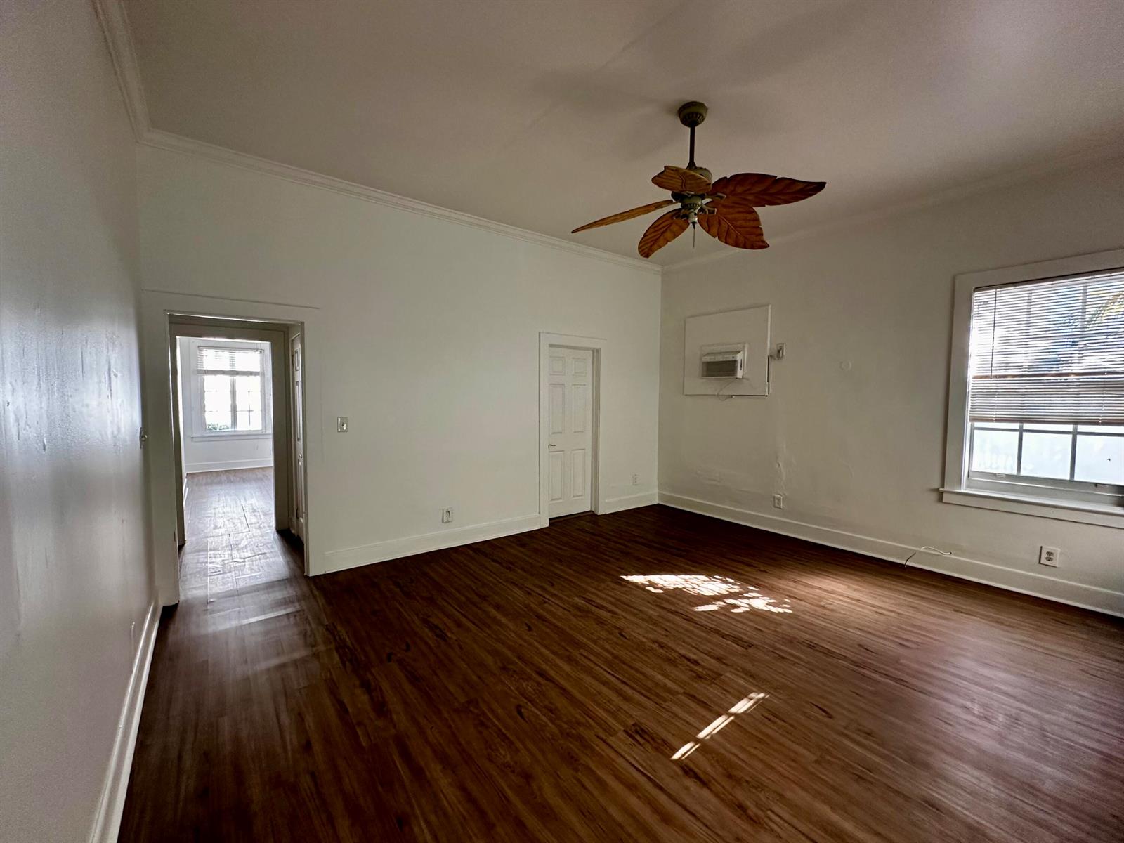 An empty room features wood-look flooring, white walls, a ceiling fan, and a window — 270 Seminole Avenue # 3, Palm Beach FL 33480, PALM BEACH, FL