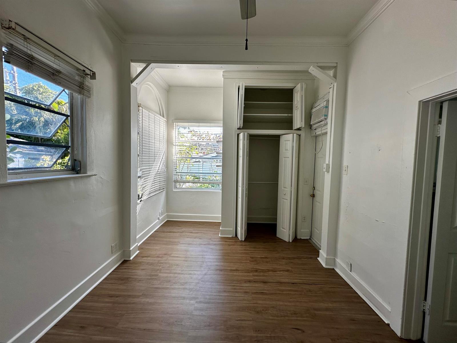 A bright room with wood-look flooring, white walls, a closet, and multiple windows — 270 Seminole Avenue # 3, Palm Beach FL 33480, PALM BEACH, FL