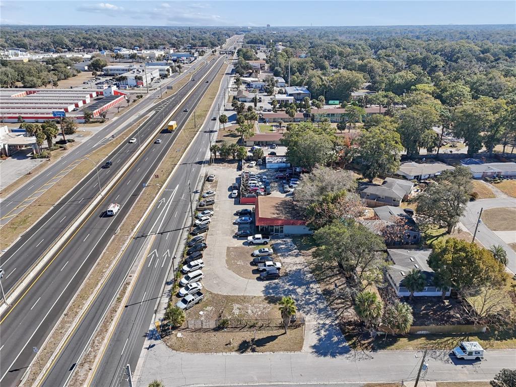 An aerial view shows a commercial property with a parking lot adjacent to a highway — 6200 ARLINGTON EXPRESSWAY, JACKSONVILLE, FL