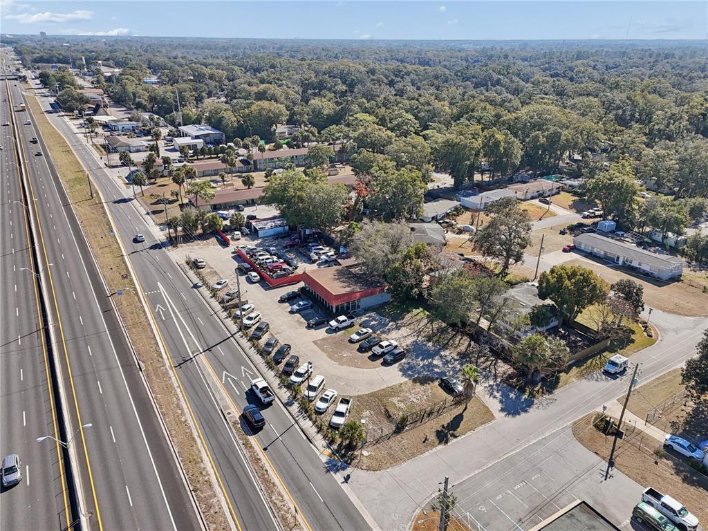An aerial view shows a commercial property with a parking lot next to a highway — 6200 ARLINGTON EXPRESSWAY, JACKSONVILLE, FL