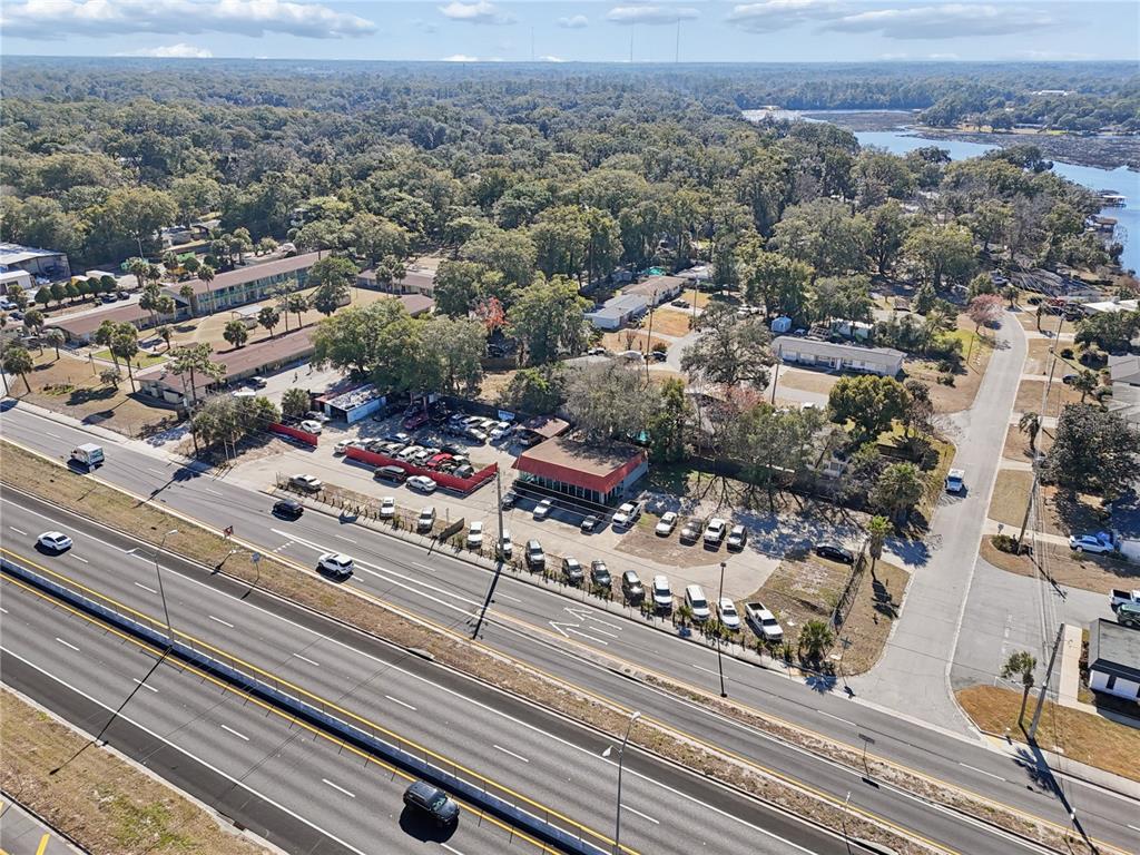 An aerial view shows a commercial property with a parking lot beside a multi-lane highway — 6200 ARLINGTON EXPRESSWAY, JACKSONVILLE, FL