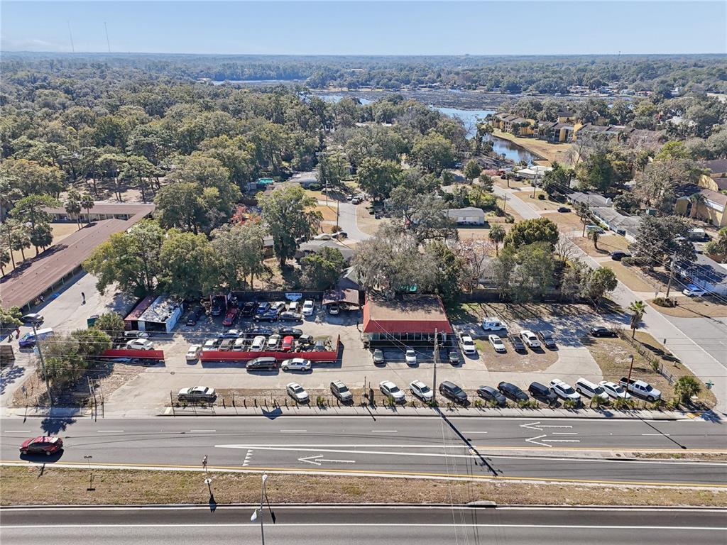 An aerial view shows a commercial car lot with a building and parking area — 6200 ARLINGTON EXPRESSWAY, JACKSONVILLE, FL