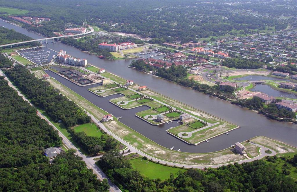 An aerial view shows a waterfront residential development with vacant lots and a boat marina — 282 YACHT HARBOR DRIVE, PALM COAST, FL
