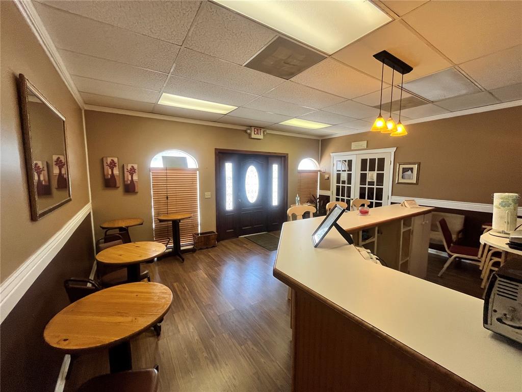 A room with a wooden bar, three white stools, and two-toned walls — 1165 1ST STREET S UNIT 1165, WINTER HAVEN, FL